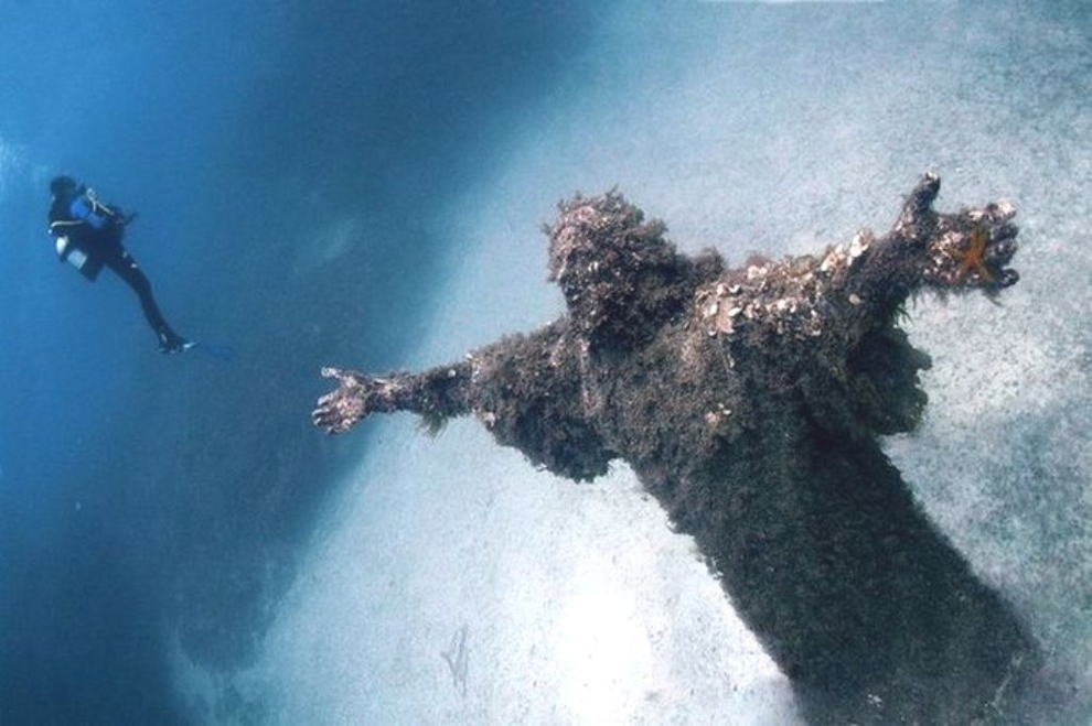 Christ of the Abyss being photographed by a diver